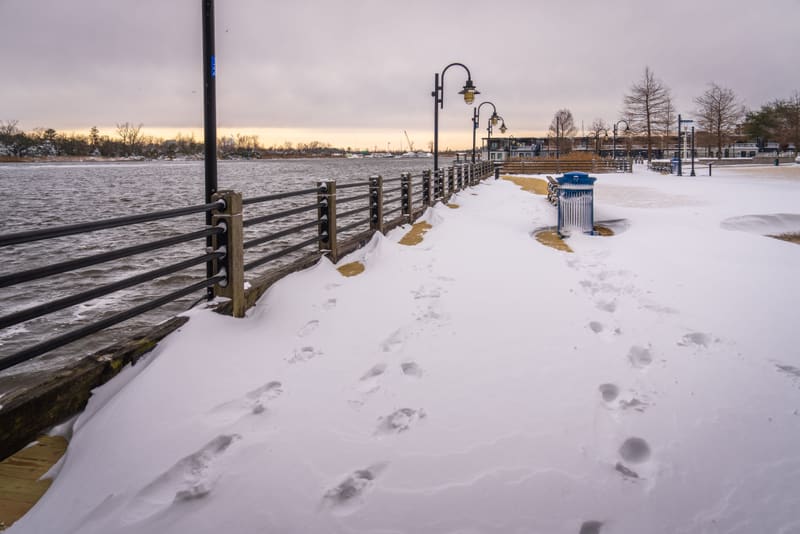 Coarse road salt scattered across an icy walkway surface