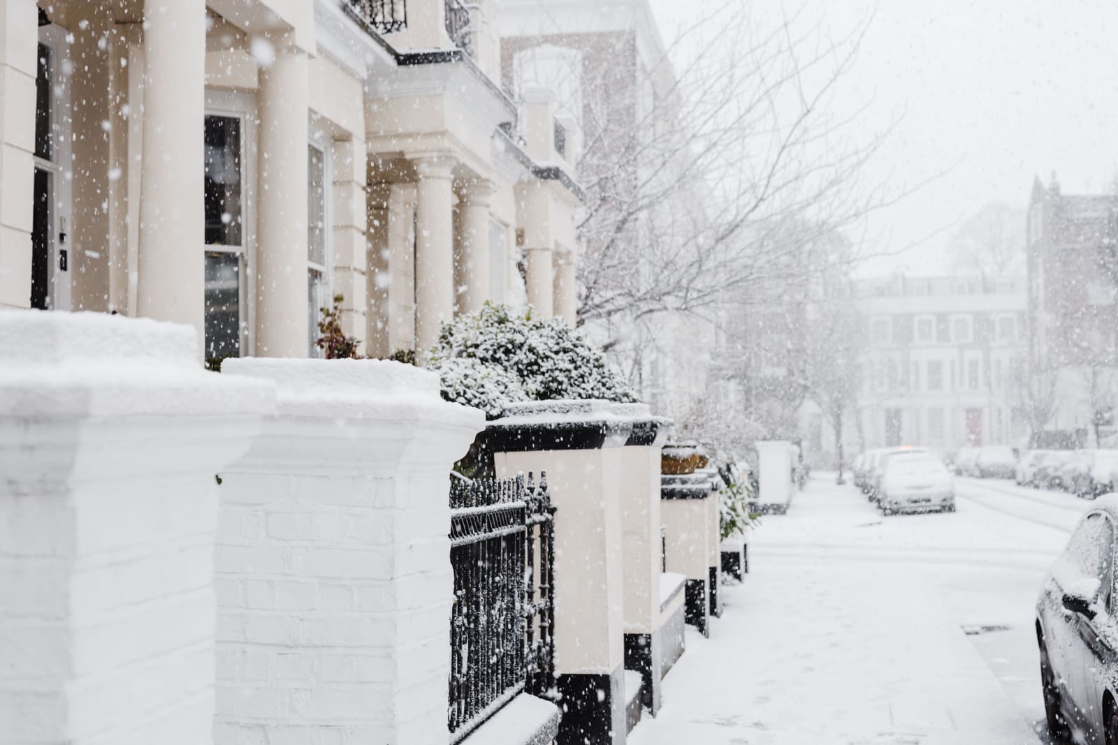Snow falling on row houses whose front steps meet the sidewalk, with no yard to put it in — the surfaces snow removal Centretown homes need cleared before morning