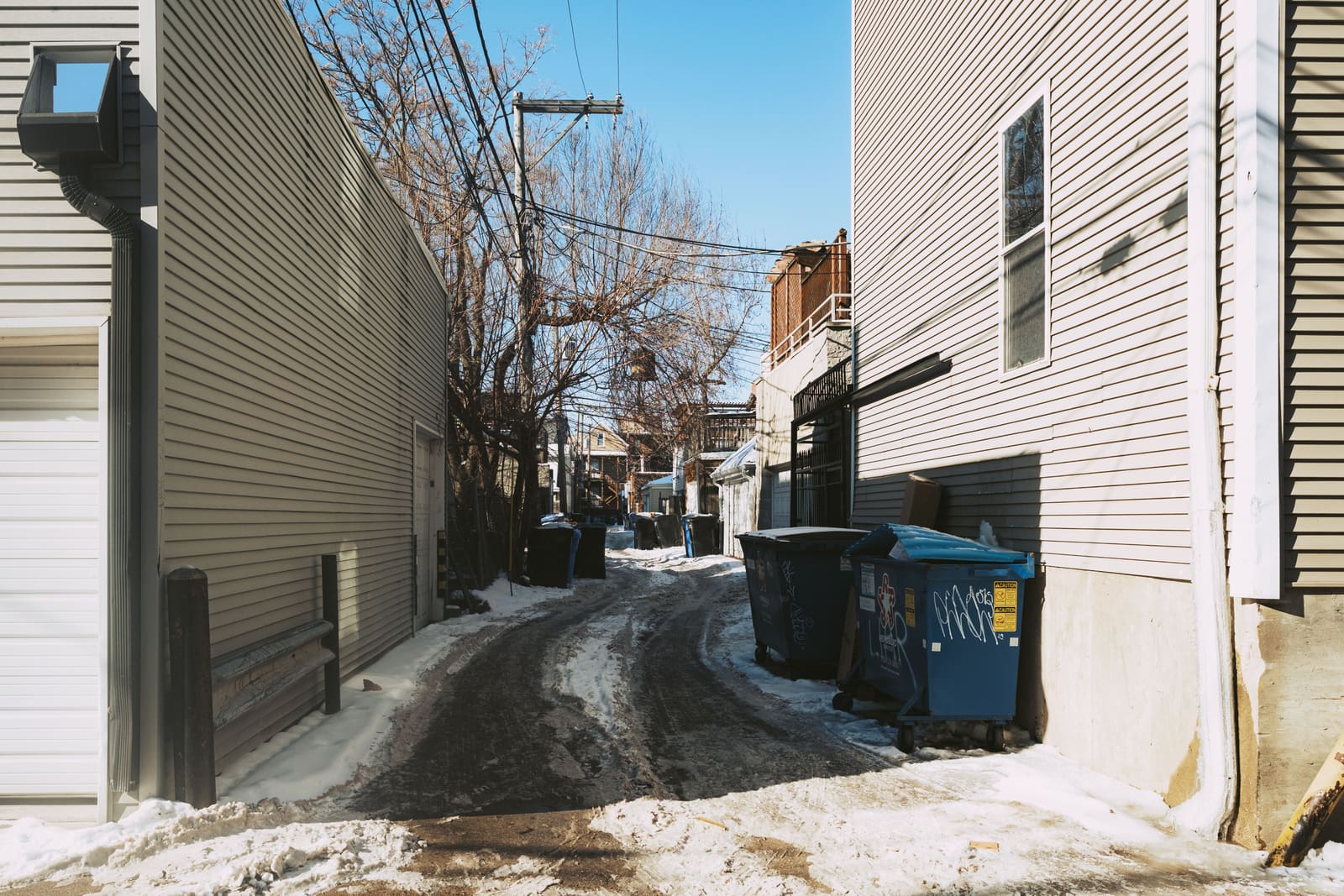 Une seule voie étroite entre les murs latéraux de deux maisons, neige tassée au milieu — la surface partagée que le déneigement au Glebe dégage d’un seul tenant